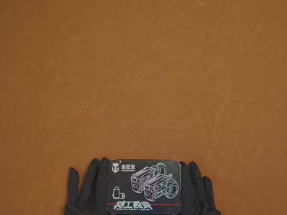 Mechanical EDC fidget revolver with rotating cylinder and ring grip, metallic silver finish, displayed on dark stone surface with modular accessories and precision details