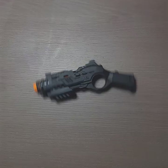 Compact EDC fidget launcher with one-button shell ejection and push-action mechanism, shown in black and tactical green finishes, designed for tactile stress relief, focus, and discreet desk play.