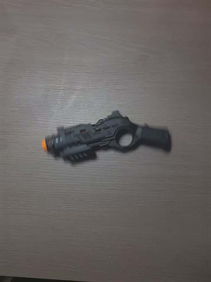 Compact EDC fidget launcher with one-button shell ejection and push-action mechanism, shown in black and tactical green finishes, designed for tactile stress relief, focus, and discreet desk play.