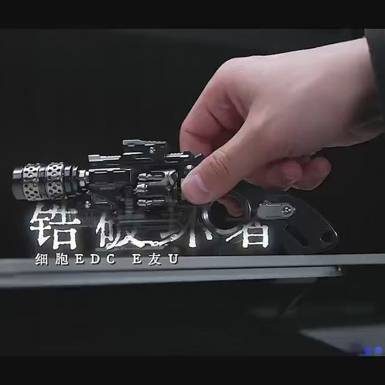 metal EDC fidget object designed with a pistol-inspired mechanical form, featuring exposed precision components, rotating elements, and modular construction for tactile interaction, focus, and stress relief.
